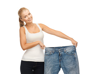 Image showing sporty woman showing big pants