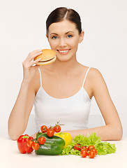 Image showing woman with hamburger and vegetables