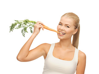Image showing healthy young woman biting carrot