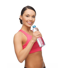 Image showing sporty woman drinking water from bottle