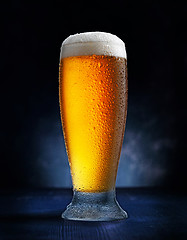 Image showing glass of beer on dark blue background