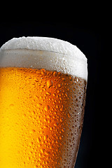 Image showing glass of beer on dark blue background