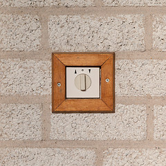 Image showing Old switch on a stone wall