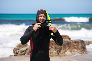 Image showing male diver with diving suit snorkel mask fins on the beach