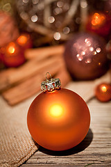 Image showing glittering christmas decoration in orange and brown natural wood 