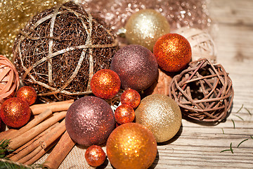 Image showing glittering christmas decoration in orange and brown natural wood 