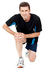 Image showing adult attractive man in sportswear knee pain injury ache isolated