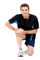 Image showing adult attractive man in sportswear knee pain injury ache isolated