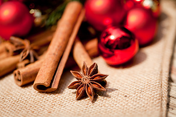 Image showing christmas decoration cinnamon anise baubles in red 