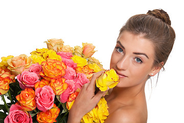 Image showing attractive young smiling woman with flowers roses isolated