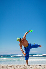 Image showing attractive man playing frisby on beach in summer