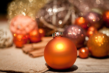 Image showing glittering christmas decoration in orange and brown natural wood 