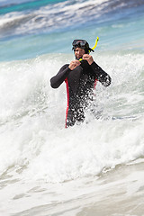 Image showing male diver with diving suit snorkel mask fins on the beach