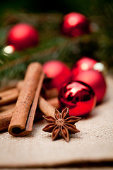 Image showing christmas decoration cinnamon anise baubles in red 