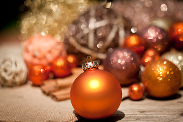 Image showing glittering christmas decoration in orange and brown natural wood 