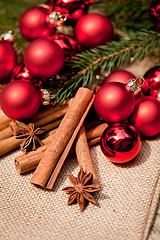 Image showing christmas decoration cinnamon anise baubles in red 