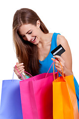 Image showing happy young woman with colorful shopping bags visa isolated