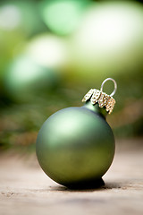 Image showing shiny green christmas baubles closeup macro and tree 