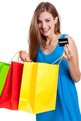 Image showing happy young woman with colorful shopping bags visa isolated