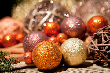 Image showing glittering christmas decoration in orange and brown natural wood 