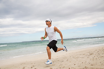 Image showing man is jogging on the beach summertime sport fitness