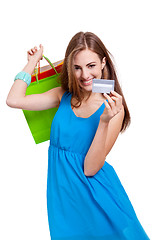 Image showing happy young woman with colorful shopping bags visa isolated