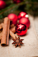 Image showing christmas decoration cinnamon anise baubles in red 