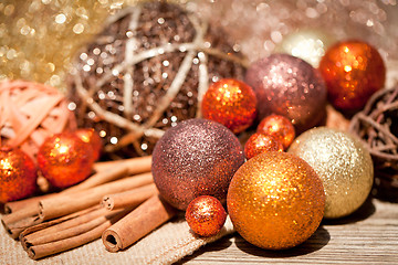 Image showing glittering christmas decoration in orange and brown natural wood 