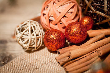 Image showing glittering christmas decoration in orange and brown natural wood 