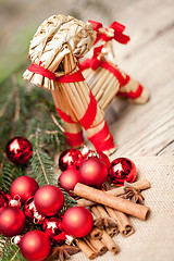 Image showing christmas decoration cinnamon anise baubles in red 