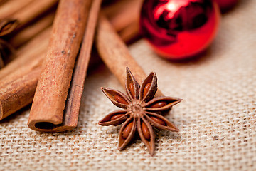 Image showing christmas decoration cinnamon anise baubles in red 