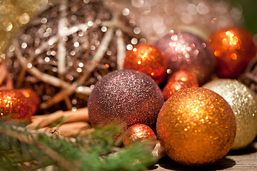 Image showing glittering christmas decoration in orange and brown natural wood 