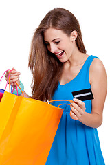 Image showing happy young woman with colorful shopping bags visa isolated