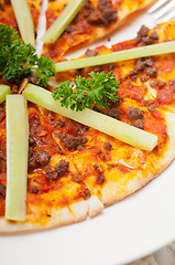 Image showing Turkish beef pizza with cucumber on top