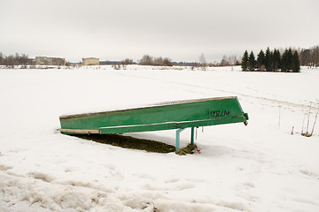 Image showing upturned wooden boat snow frozen lake bank winter 