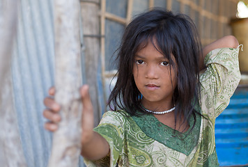 Image showing A young girl lives in a fishing village and tourist poses for a 