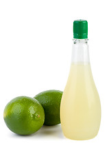 Image showing Two limes and bottle of juice