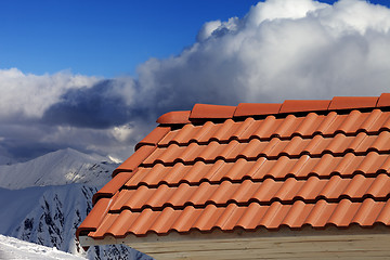 Image showing Roof tiles against winter mountains