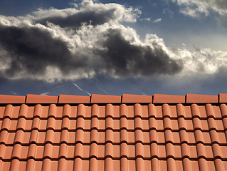 Image showing Roof tiles and storm sky