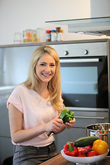 Image showing Happy woman cooking a meal in the kitchen