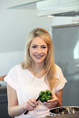 Image showing Beautiful woman slicing a green pepper