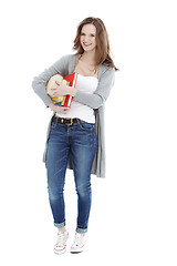 Image showing Happy young student carrying her books