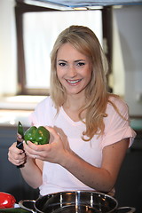 Image showing Young woman preparing vegetables