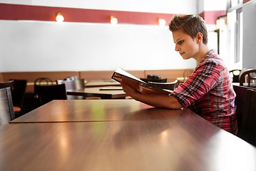 Image showing Young happy woman in a restaurant