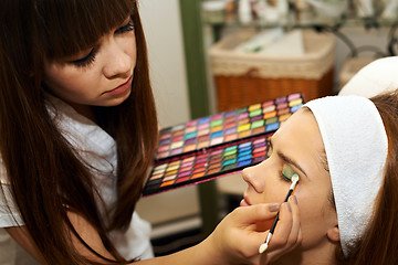 Image showing Young woman getting beautiful makeup