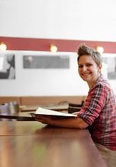 Image showing Young happy woman in a restaurant