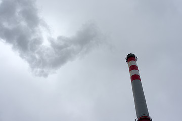 Image showing Industrial chimney against cloudy sky