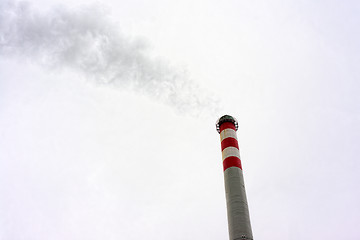 Image showing Industrial chimney against cloudy sky