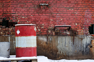 Image showing Red brick wall with barrel