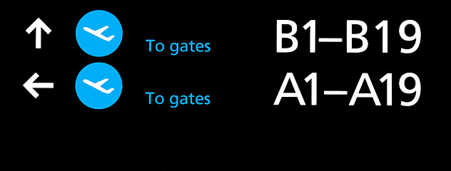 Image showing Black airport terminal sign with blue symbols